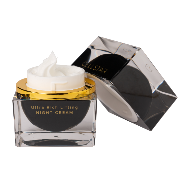 Zu sehen ist die Cellstar Ultra Rich Lifting Night Cream mit geöffnetem Deckel. Die Creme ist eine luxuriöse Nachtpflege für die Haut ab 45 Jahren. Mit hochdosierten Wirkstoffen reduziert sie Falten, festigt die Gesichtskontur und beruhigt die Haut. Sie fördert die Elastizität, unterstützt die Zellneubildung und regeneriert die Haut im Schlaf. Die Creme regt die Bildung von Elastin und Kollagen an und spendet intensive Feuchtigkeit für ein straffes, verjüngtes Hautbild.